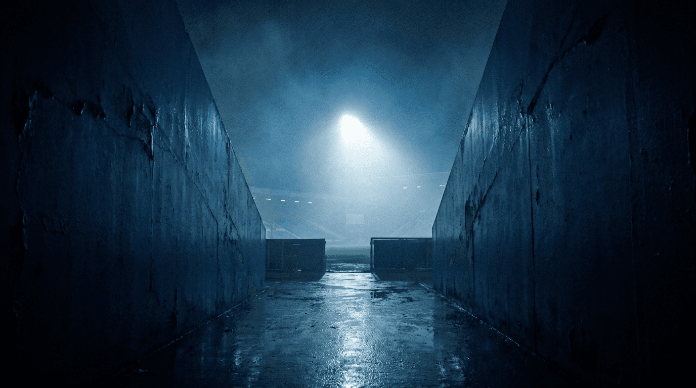 A stadium tunnel leading toward a bright spotlight, atmospheric and moody.